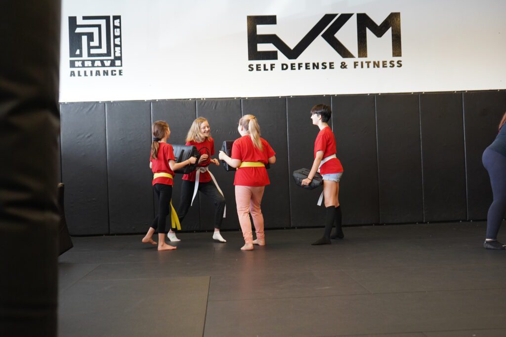 Children practicing pad drills during kids Krav Maga class in Tempe Arizona