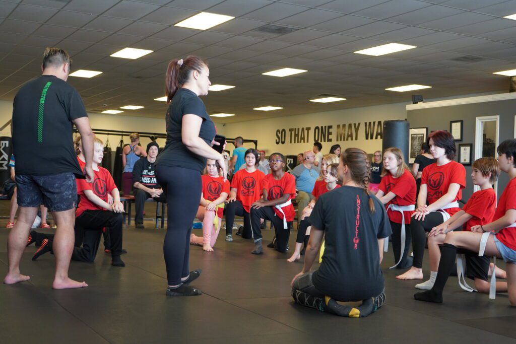 Children receiving coaching during kids martial arts training session in Tempe Arizona