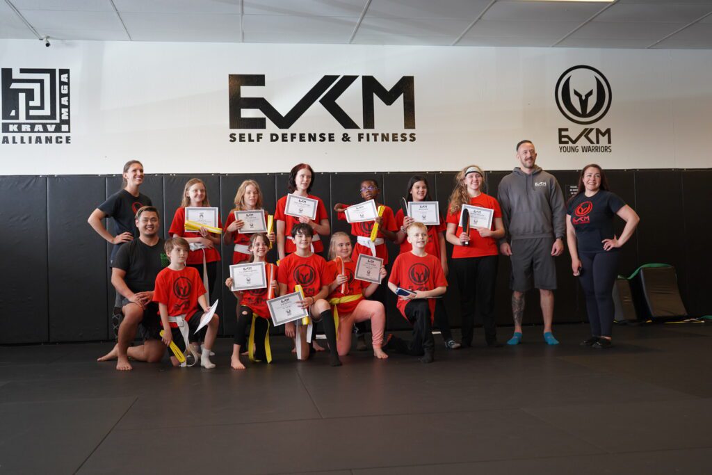 Kids holding certificates during youth Krav Maga belt promotion ceremony in Tempe Arizona